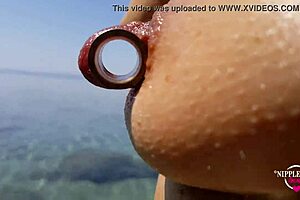 nippleringlover pisses on nude beach flashing pierced pussy nipples wide
