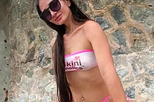 Petite brunette in bikini chills on beach then flashes pretty tits publicly